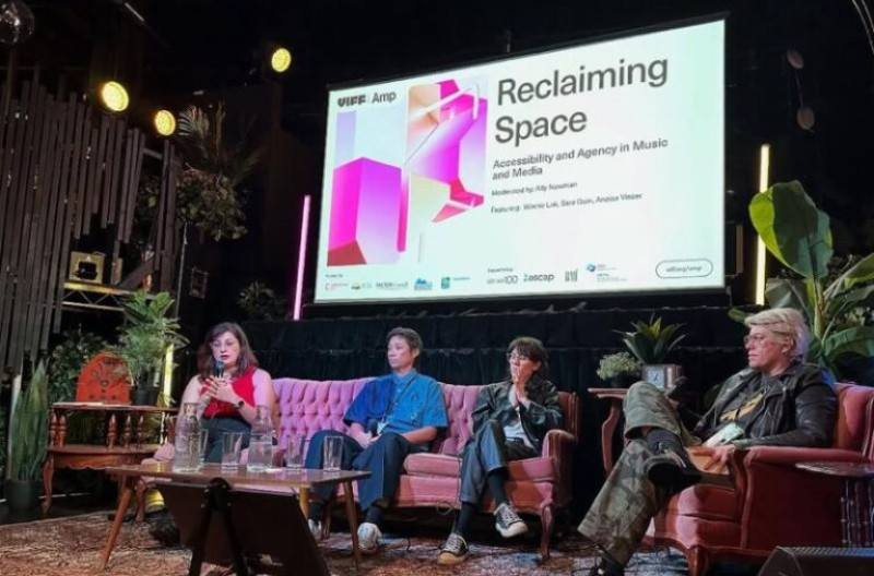 Four speakers sit on a stage during a panel discussion titled Reclaiming Space: Accessibility and Agency in Music and Media at VIFF Amp.
